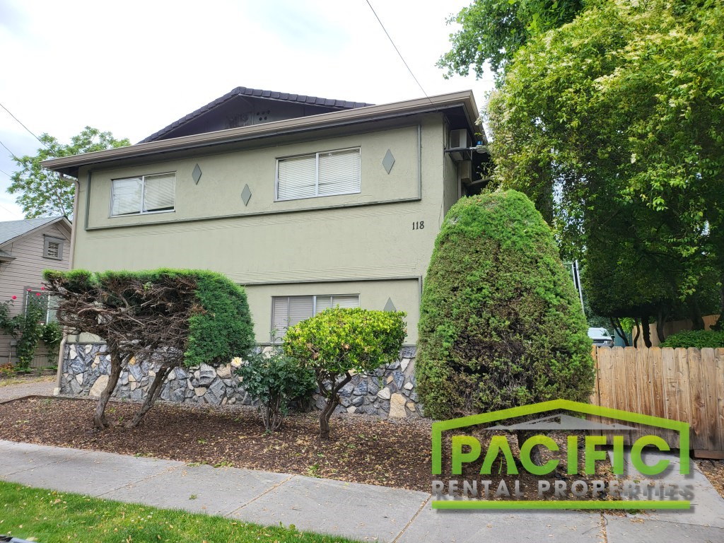 a house with a yard and a sidewalk in front of it