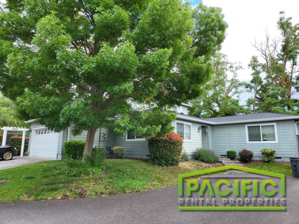 a blue house with a tree in the front