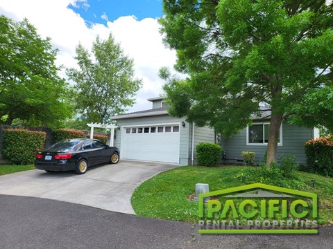 a car parked in a driveway in front of a house