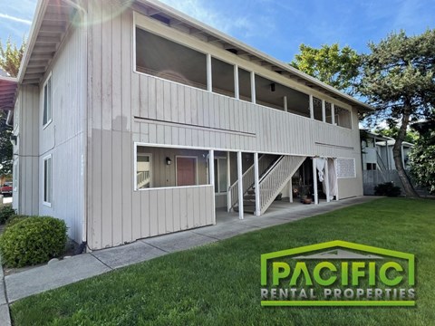 a white house with a lawn in front of it