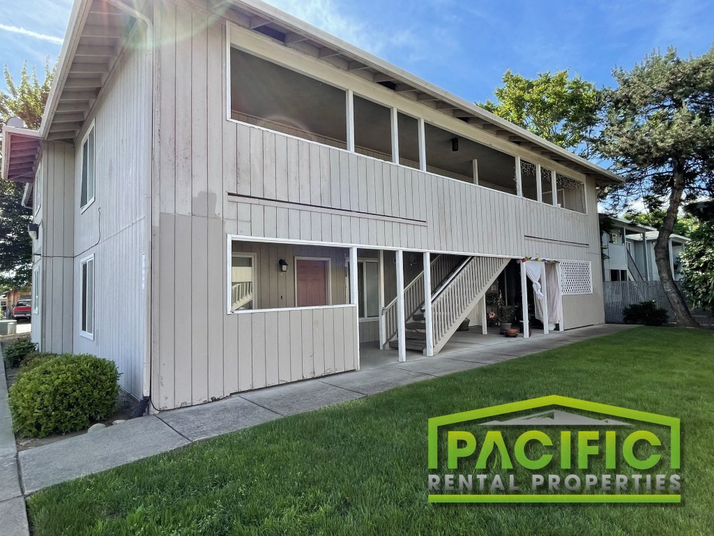 a white house with a lawn in front of it