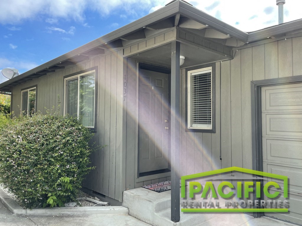 a remodeled home with a front porch and a logo for pragmatic residential properties