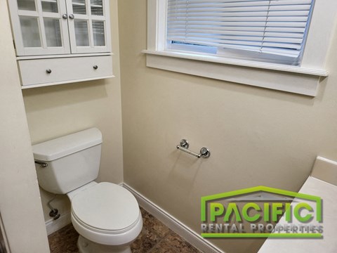 a small bathroom with a toilet and a window