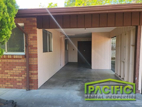 a house with a concrete driveway with a patch central properties logo