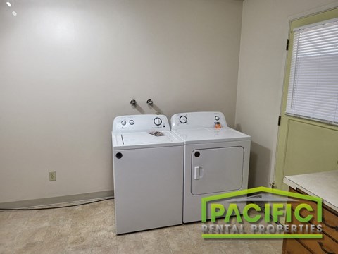 a laundry room with a washer and dryer in it