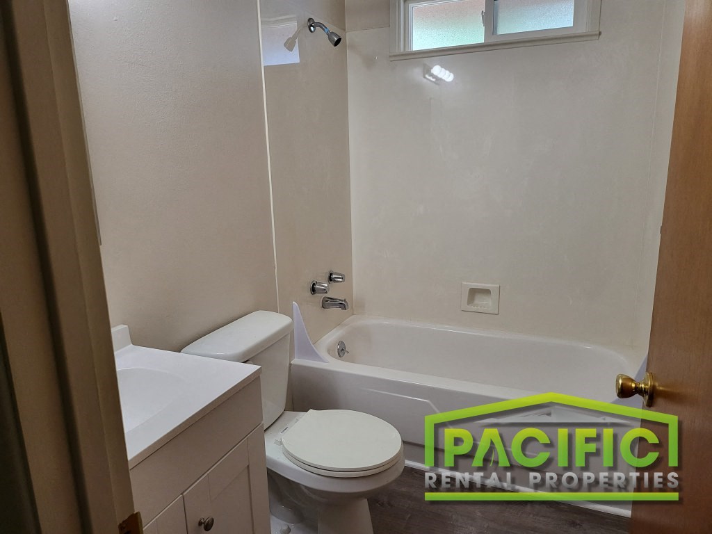 a bathroom with a toilet and a bath tub