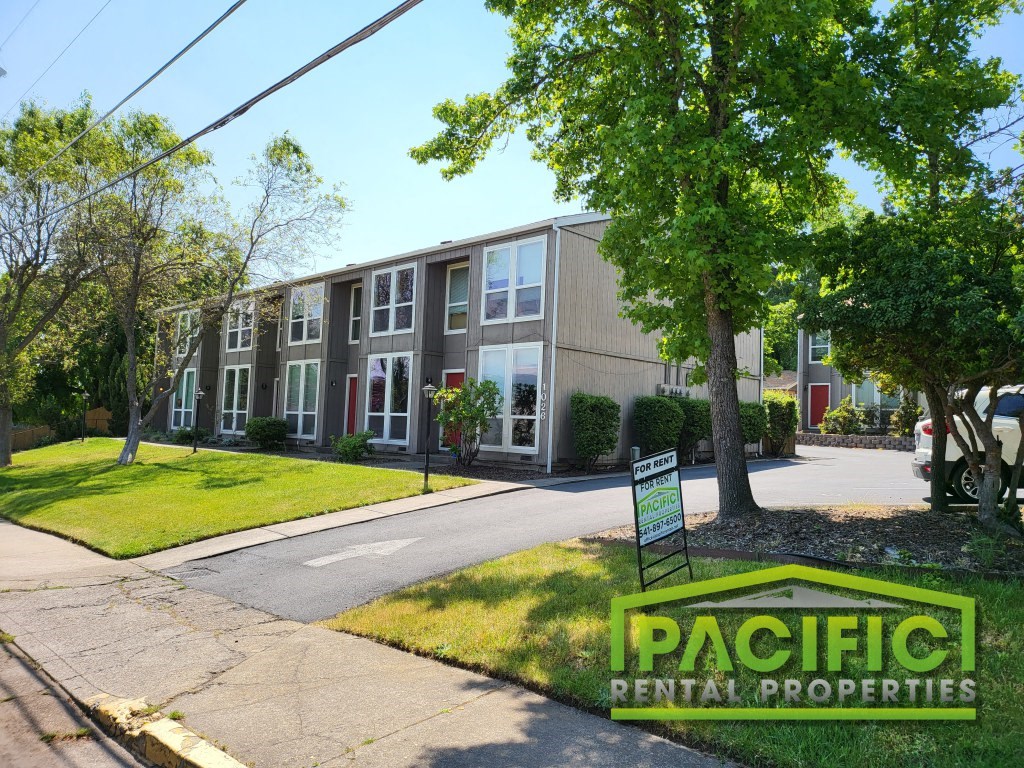 an apartment building with a sign in front of it