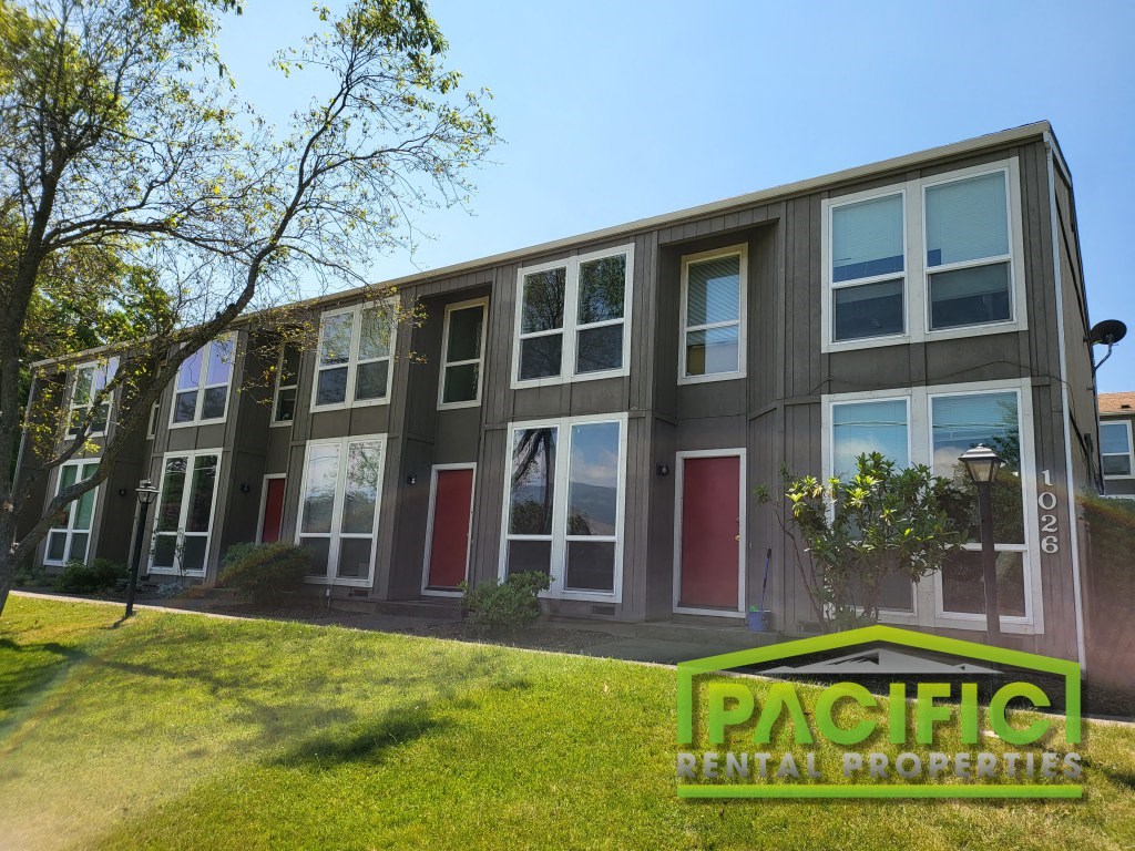a building with a green sign in front of it