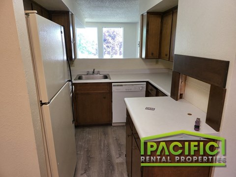 a small kitchen with a refrigerator and a sink