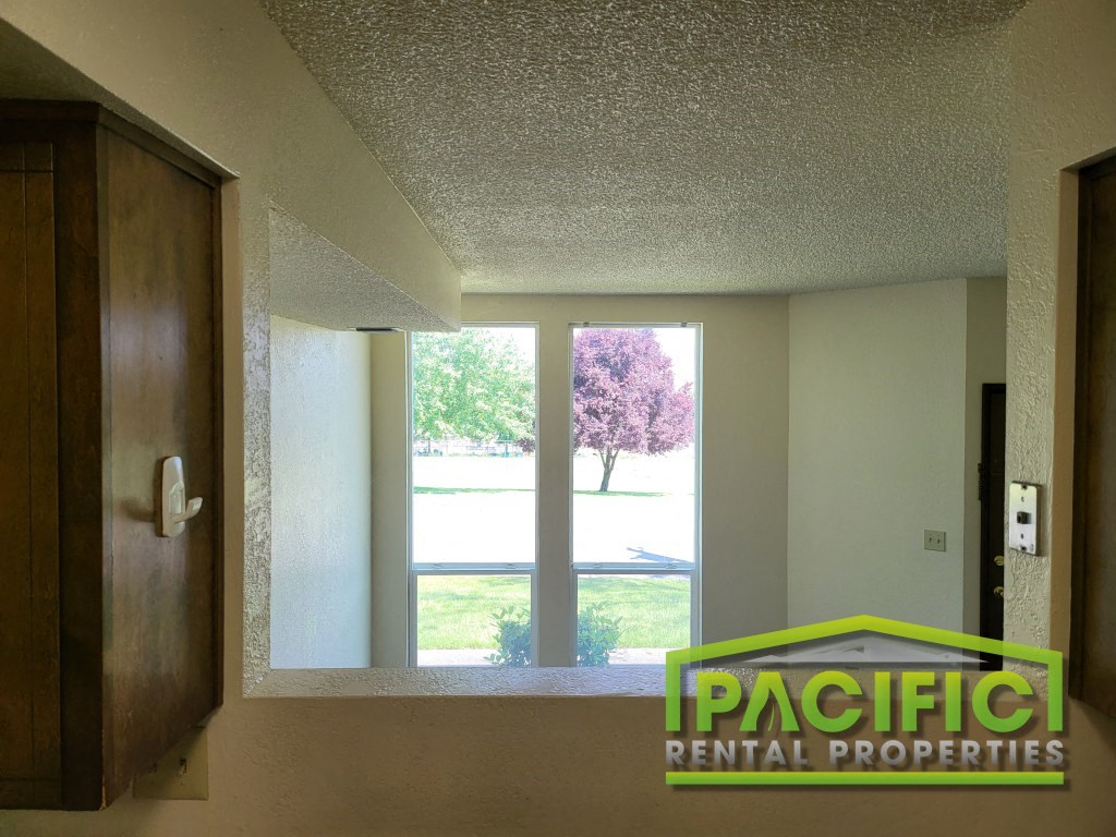 an empty room with a window and a pacific dental properties logo