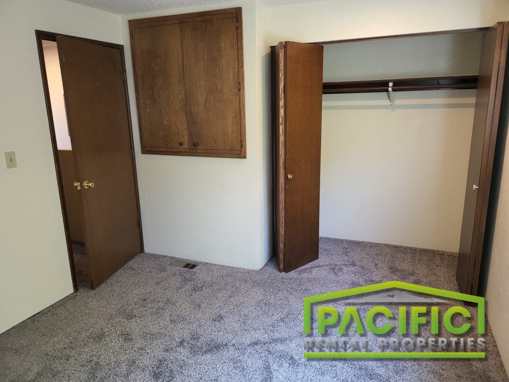 a empty closet in a room with a carpeted floor