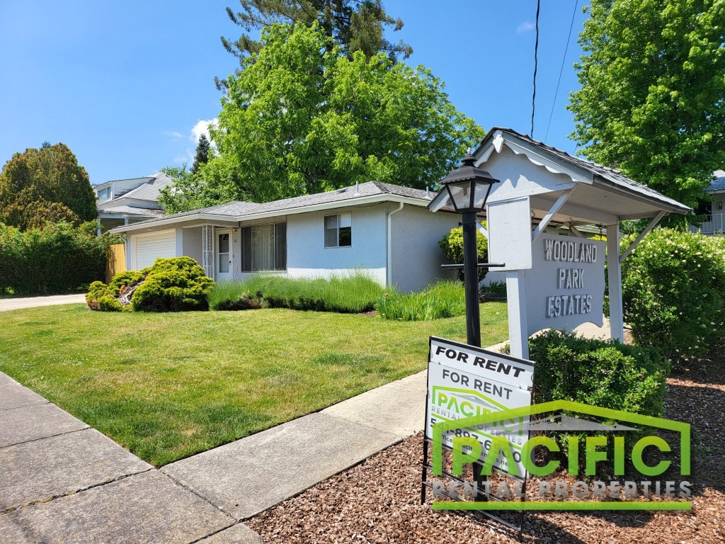 a house with a for rent sign in front of it