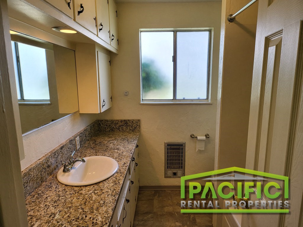 a bathroom with a sink and a window