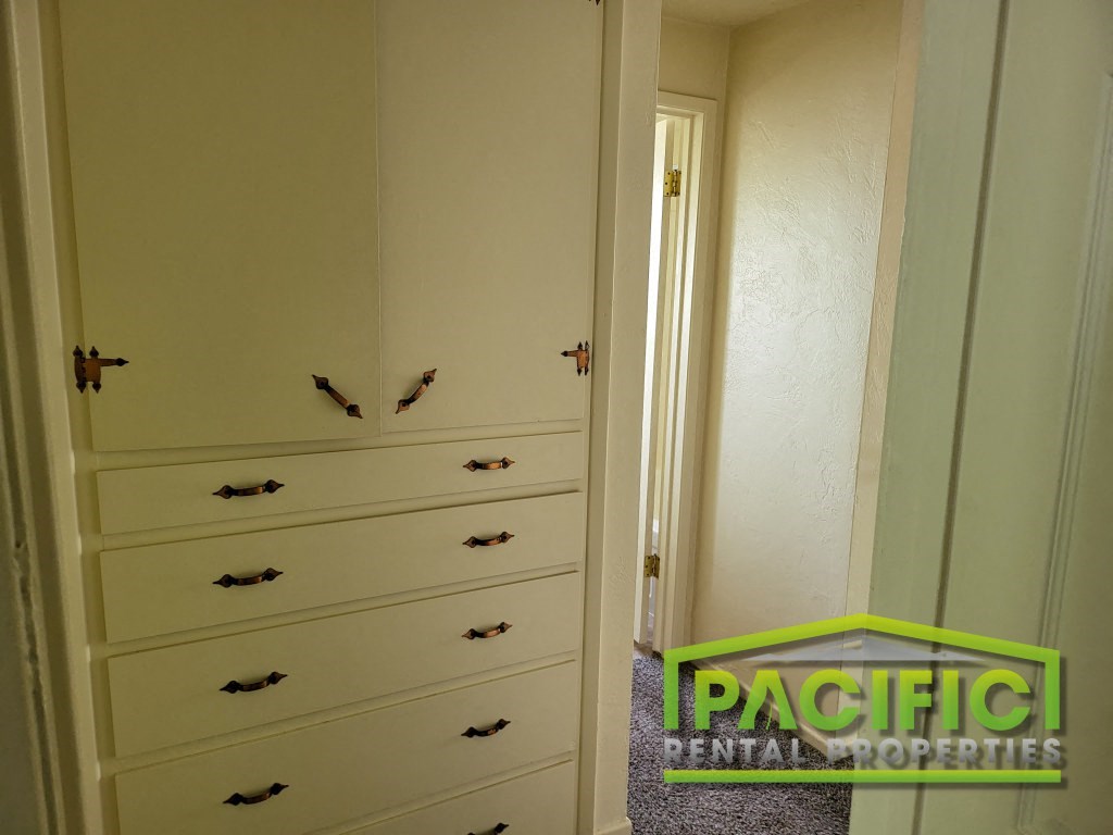 a row of drawers in a closet next to a door
