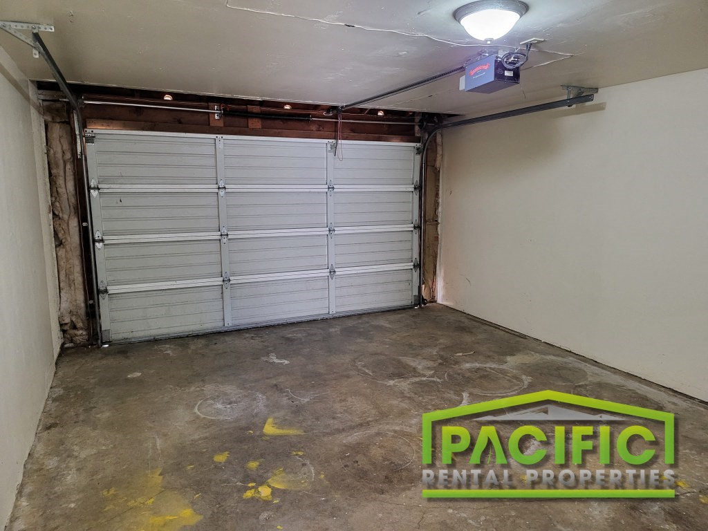 the garage door is closed and the cement floor is empty