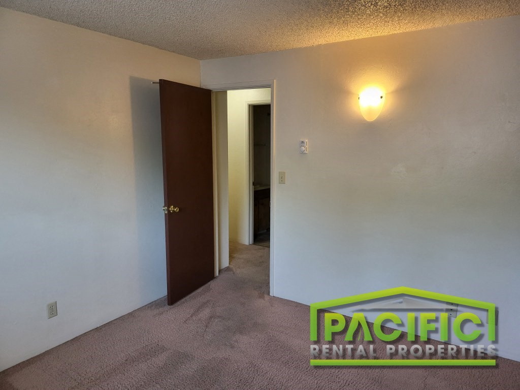 the interior of a room with a hallway and a door to a closet