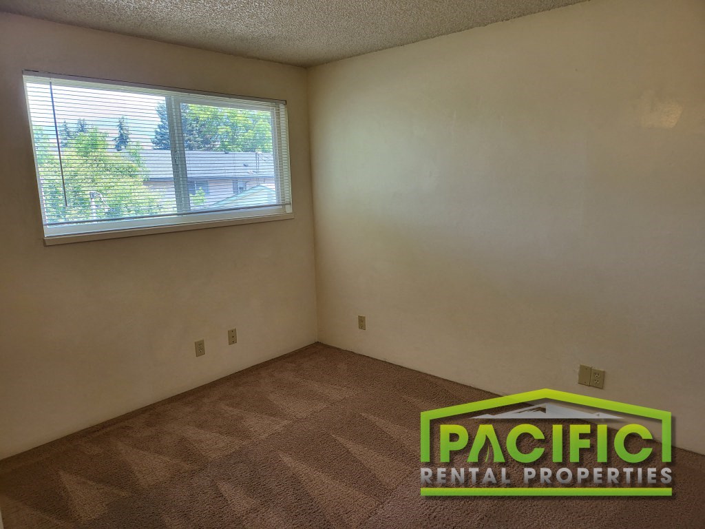the living room of an empty house with a window