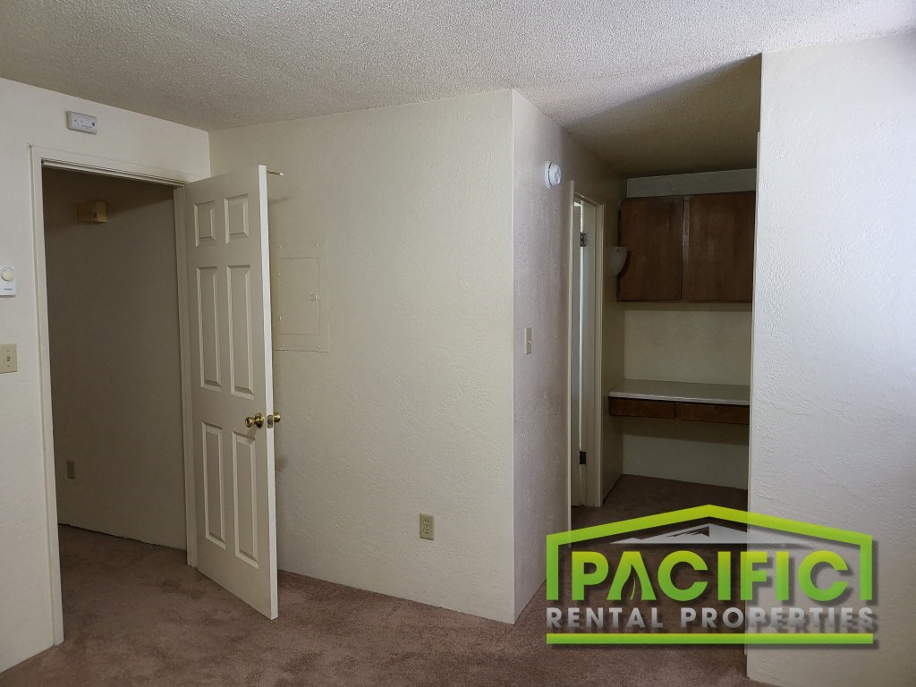 the interior of a room with an open door and a closet