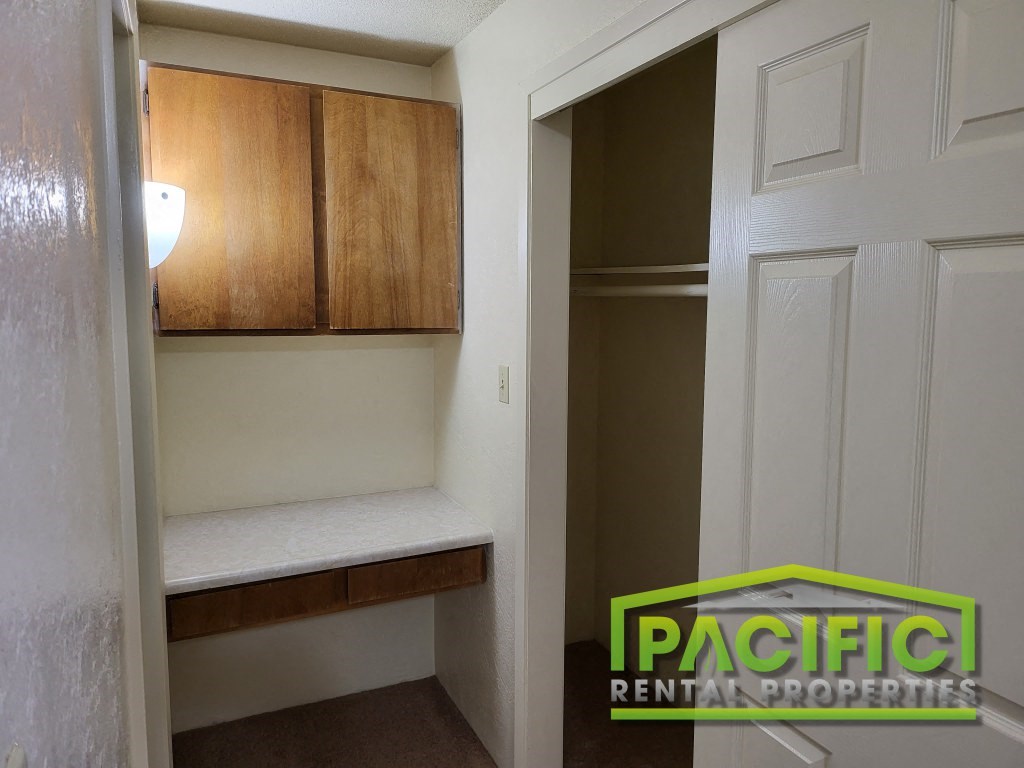 a small room with a closet and a white door