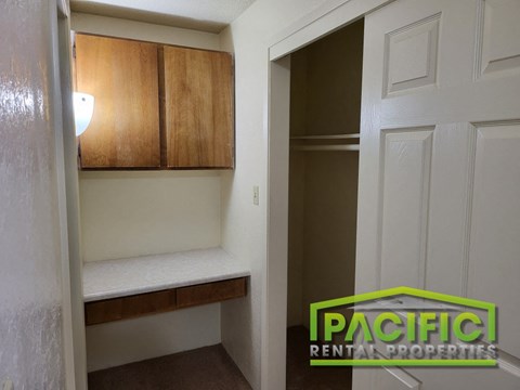 a small room with a closet and a white door