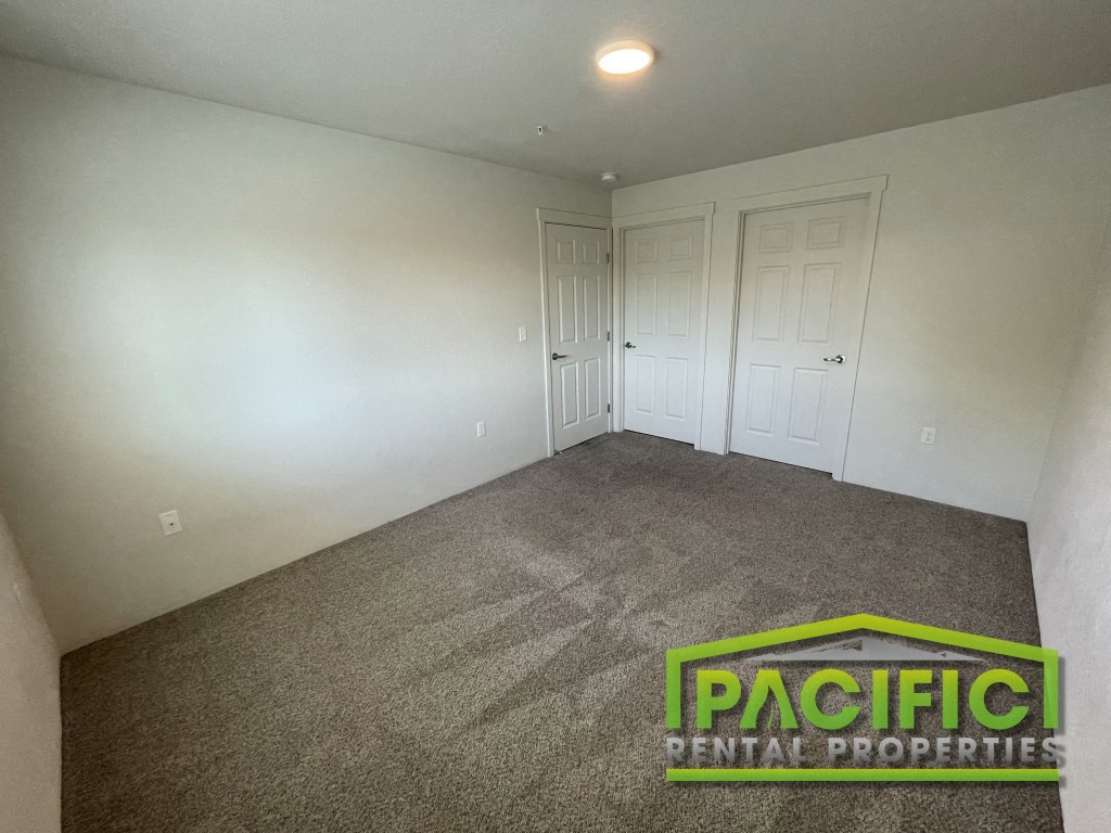 a room with a carpeted floor and white walls