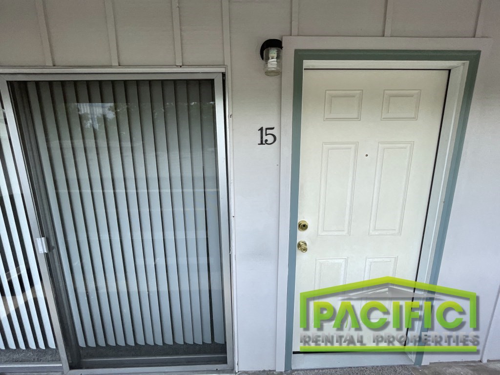 the front door of a building with a security door and a pacific dental office