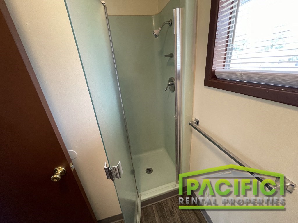 a small shower in a bathroom with a glass door