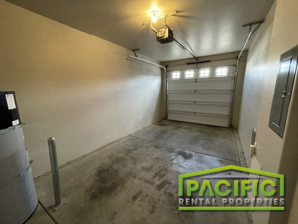 a garage with a white wall and a garage door