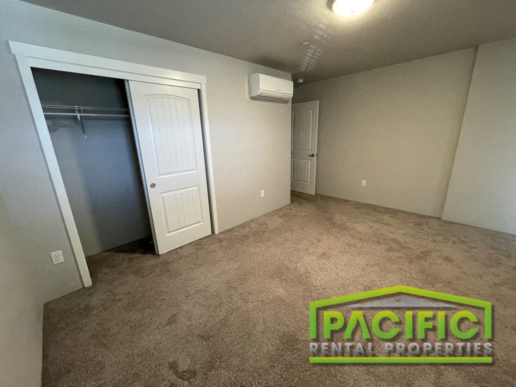 a room with a carpeted floor and a closet