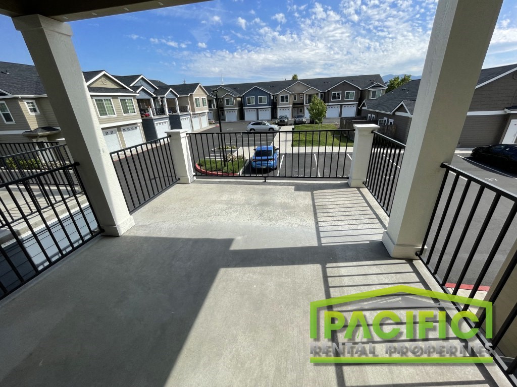a view from the deck of a home with a car parked on it