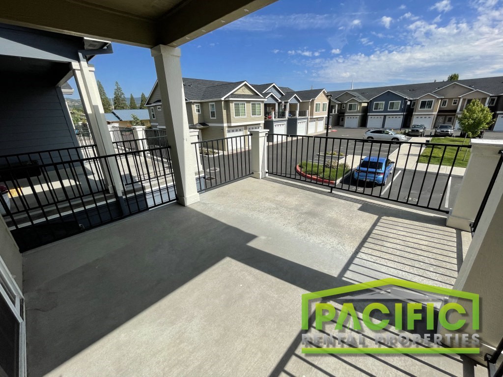 a balcony or terrace with a view of a yard and houses