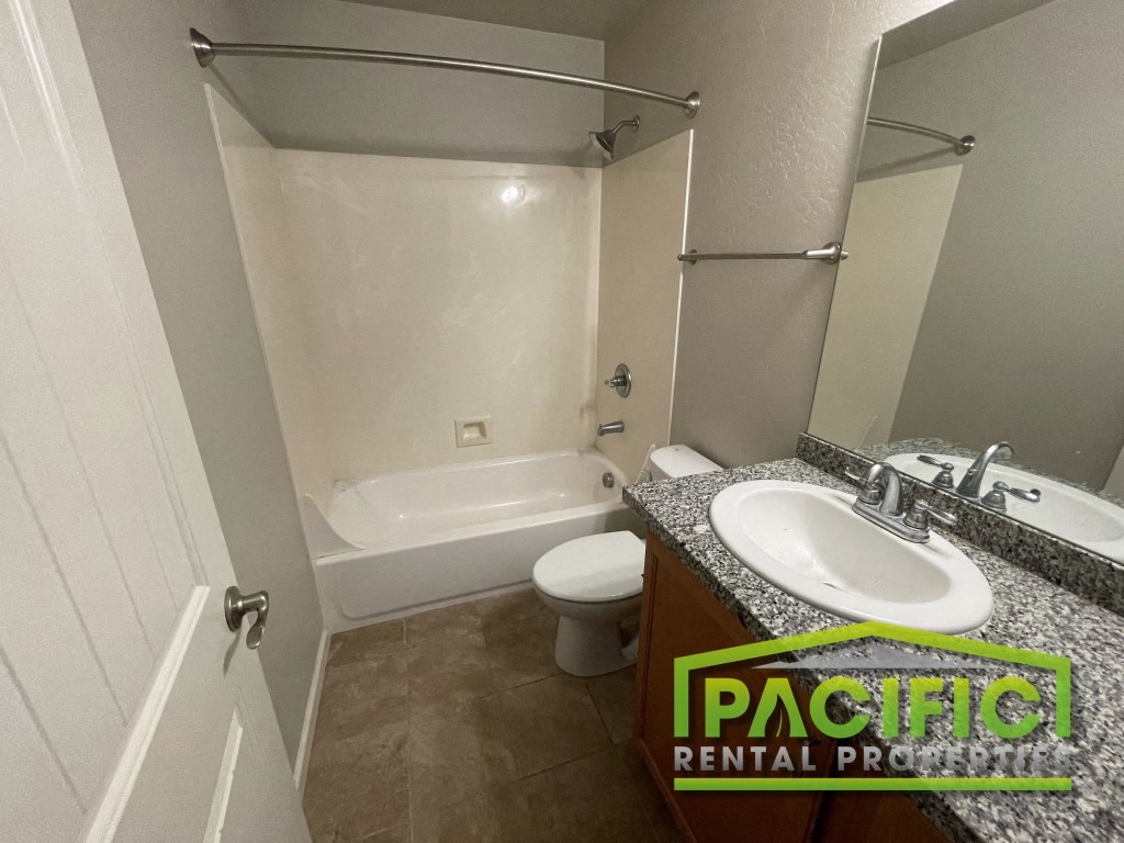 a bathroom with a sink toilet and a bath tub