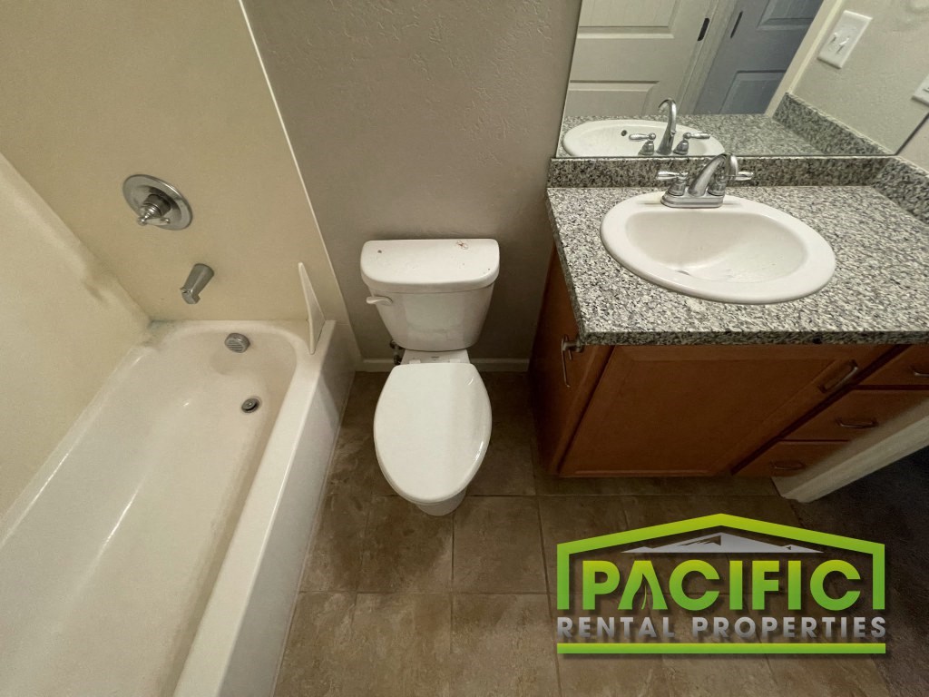 a bathroom with a sink toilet and bath tub