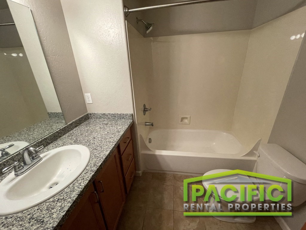 a bathroom with a tub and a sink and a mirror