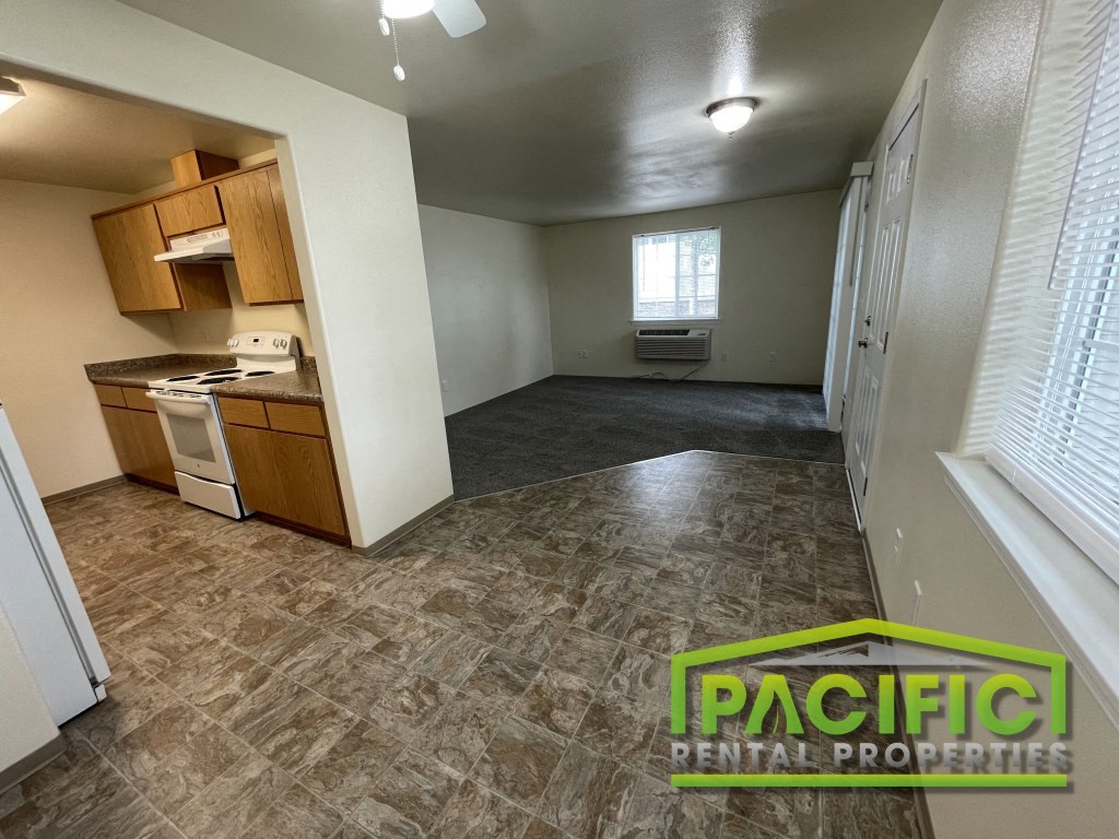 an empty kitchen and living room of a house