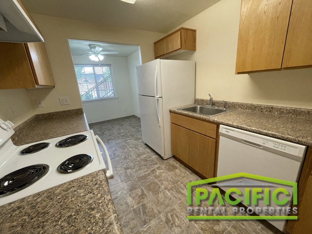 a kitchen with a stove refrigerator and a sink