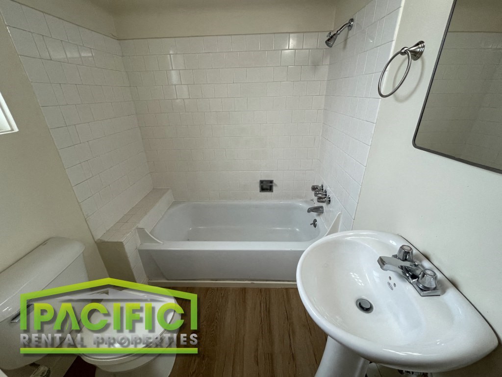 a small bathroom with a sink and a bath tub