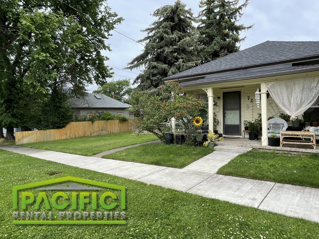 a patio in a yard in front of a house
