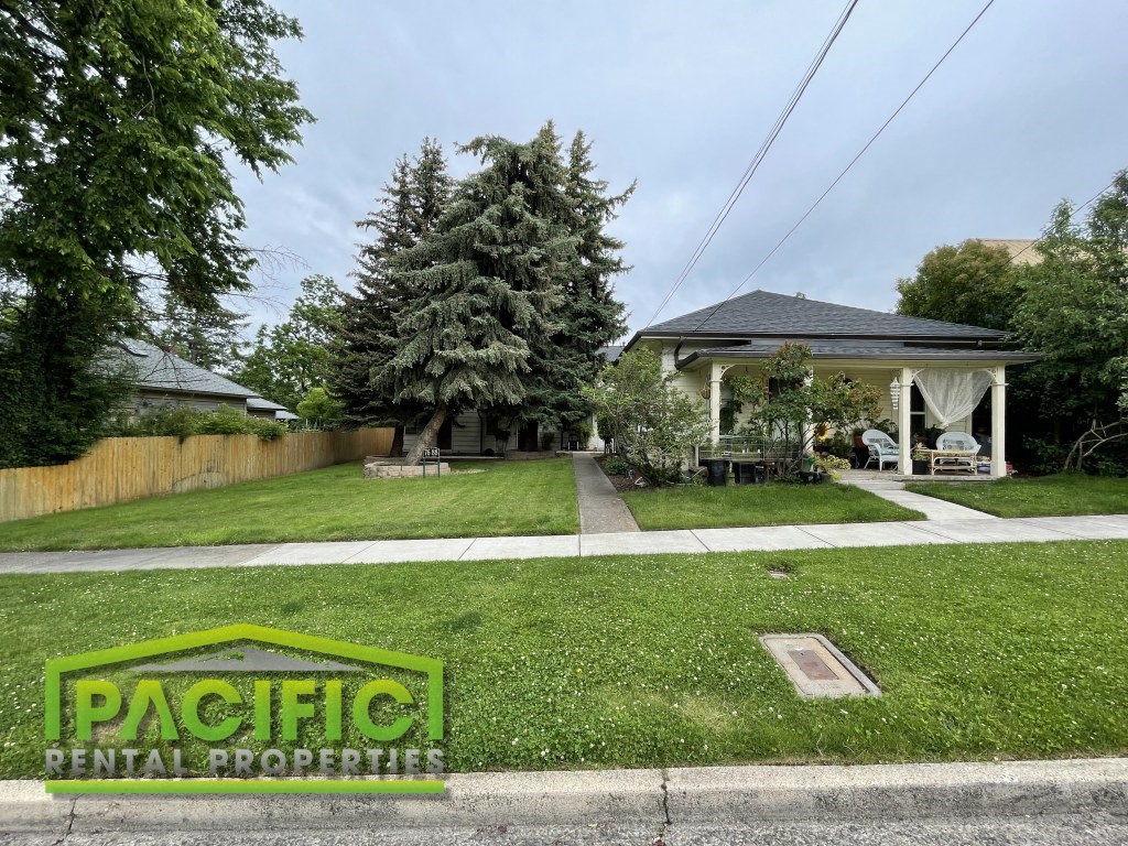 a yard with a house and a lawn and a sidewalk