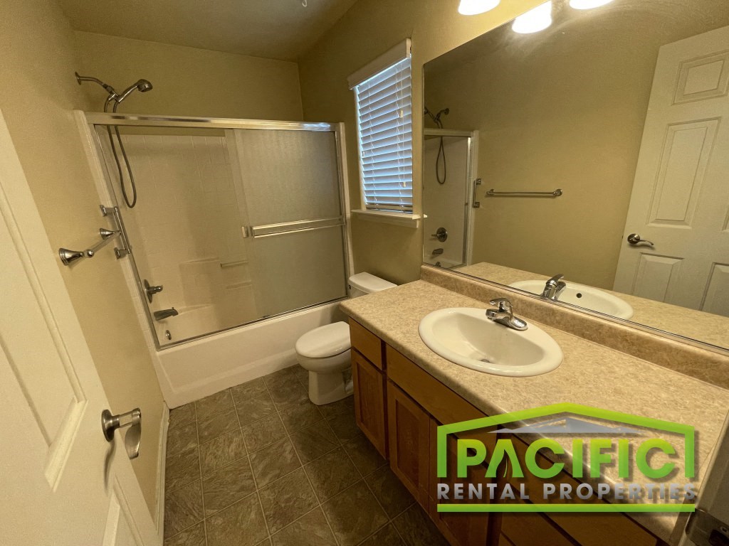 a bathroom with a sink toilet and a shower