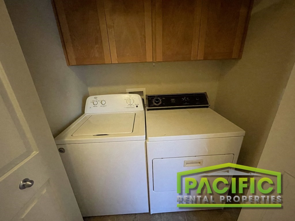 a laundry room with a washer and dryer in it