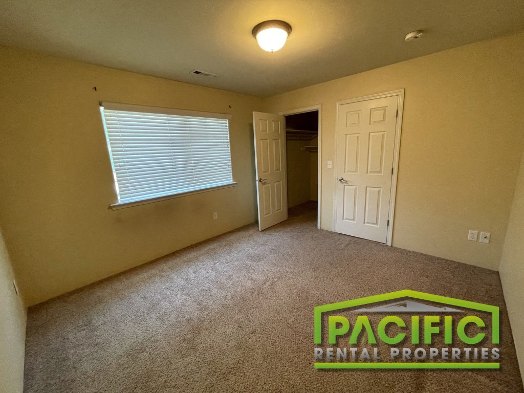 an empty room with a window and a door