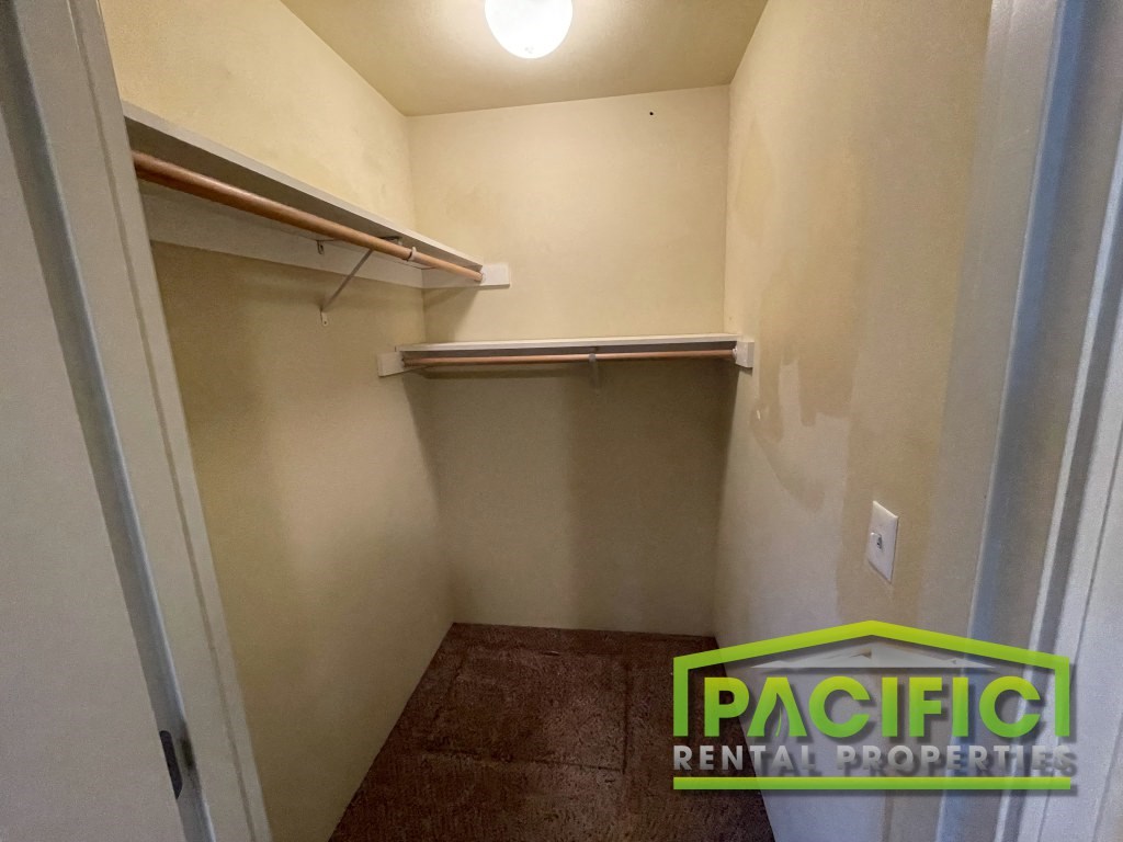 a walk in closet in an empty closet in a rental property with a patch rental