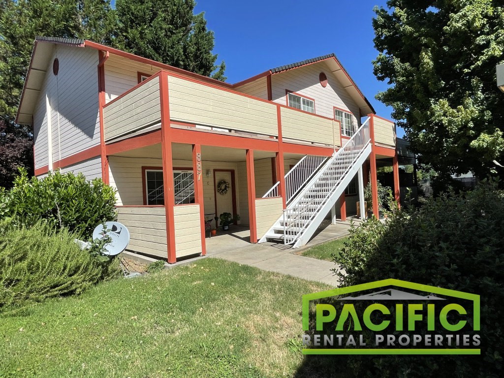 an image of a house with a pacific rental properties logo on it