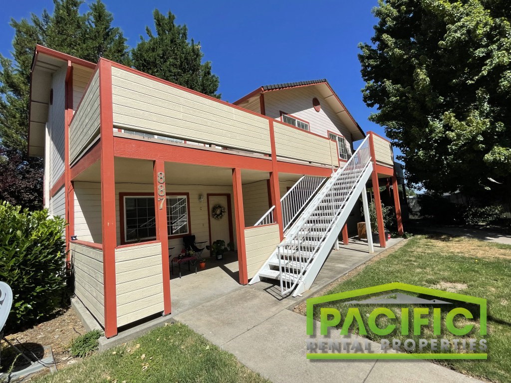 a small house with a porch and stairs