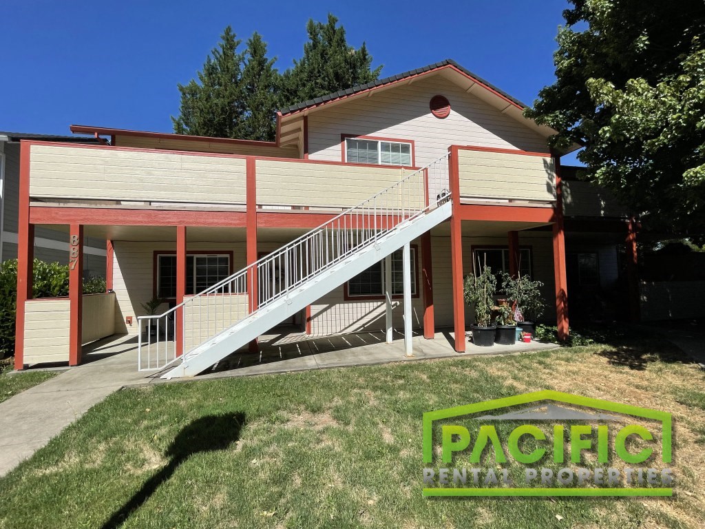 a house with a ramp and a lawn in front of it