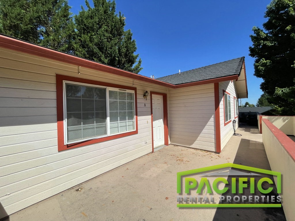 the front of a house with a driveway and a garage door