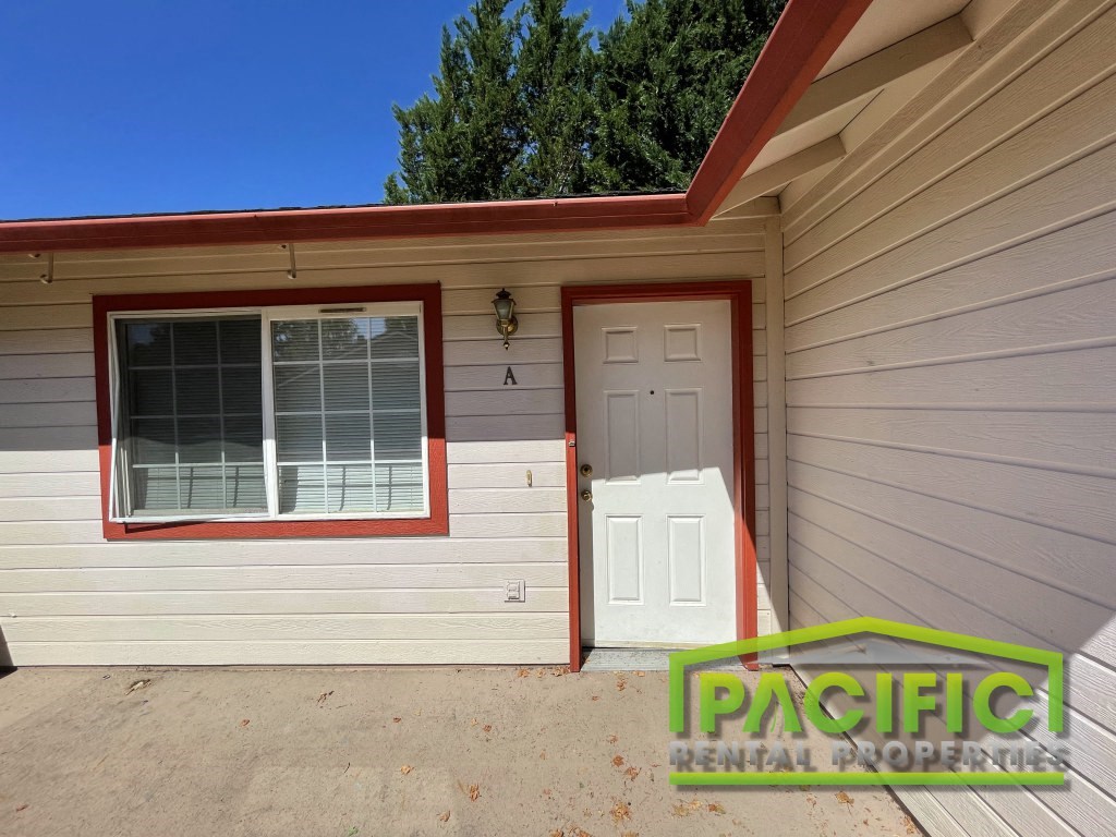 a home with a white door and a white garage door