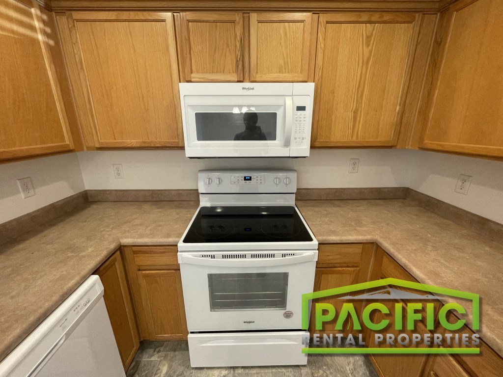 a kitchen with a stove and a microwave