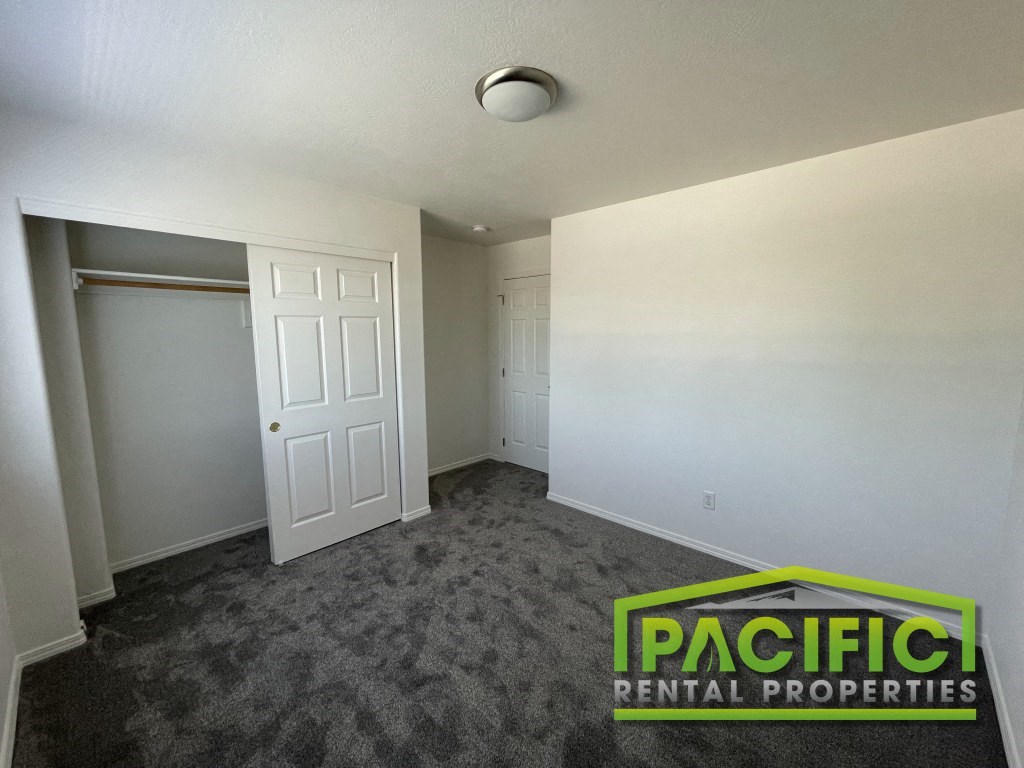 a empty room with a closet and a door